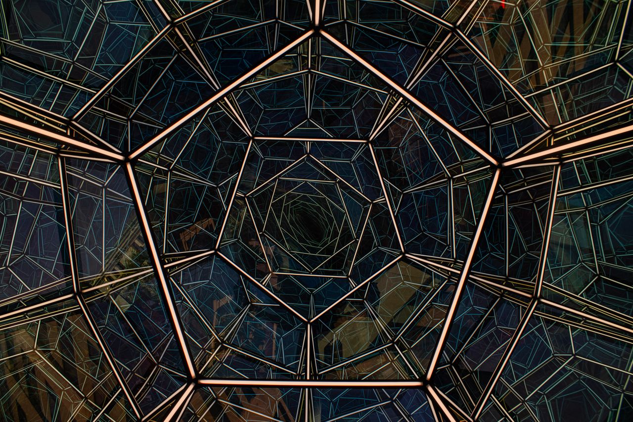 Abstract view of an intricate geometric glass roof from below, showcasing modern architectural design in Washington, D.C.
